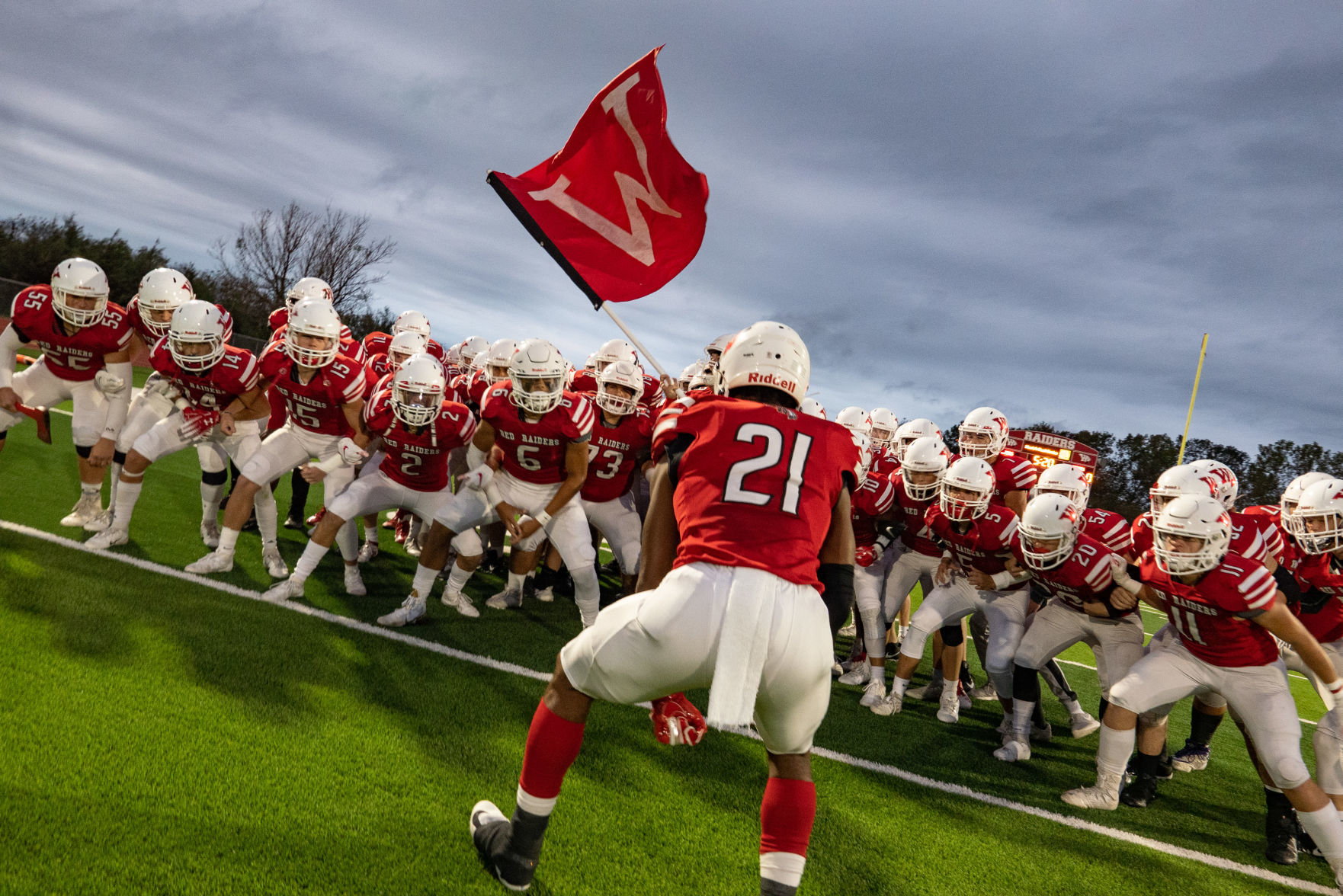 Isiah Childs leads Wamego Red Raiders onto the field